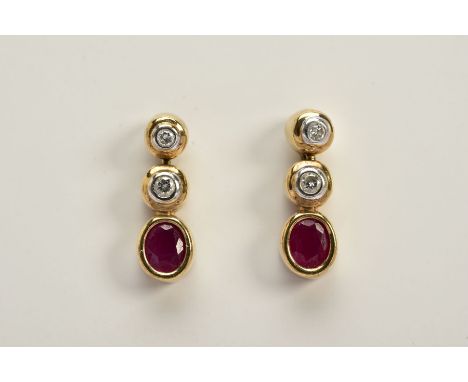 A PAIR OF 9CT GOLD DIAMOND AND RUBY DROP EARRINGS, each designed with two round brilliant cut diamonds each in a collet mount