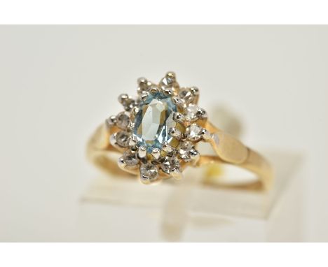 A 9CT GOLD AQUAMARINE AND DIAMOND CLUSTER RING, set with a central oval cut aquamarine within a single cut diamond surround, 