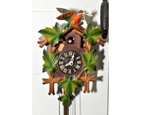 A MID TWENTIETH CENTURY CUCKOO CLOCK, with pendulum and weights height approximately 27cm