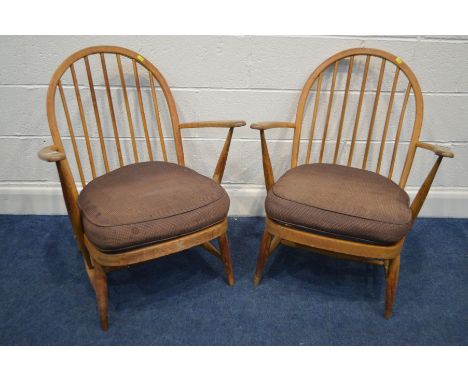 A PAIR OF ERCOL WINDOR MODEL 334E BEECH EAST ARMCHAIRS, the hoop back with spindles, spring seat and loose cushions (the cush