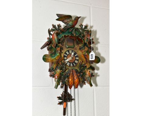 A MID TWENTIETH CENTURY cuckoo clock with pendulum and weights, height approximately 33cm