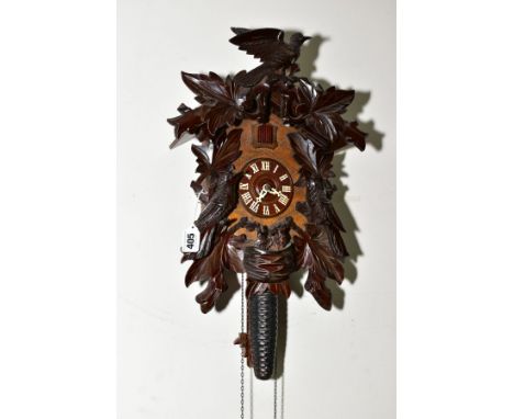 A 20TH CENTURY BLACK FOREST STYLE CUCKOO CLOCK, carved bird and leaf pediment and case sides, with birds in a nest towards th