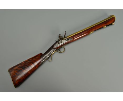 A FLINTLOCK BLUNDERBUSS, fitted with a flared muzzle 16 inches brass barrel, the top of the barrel bears the makers name and 