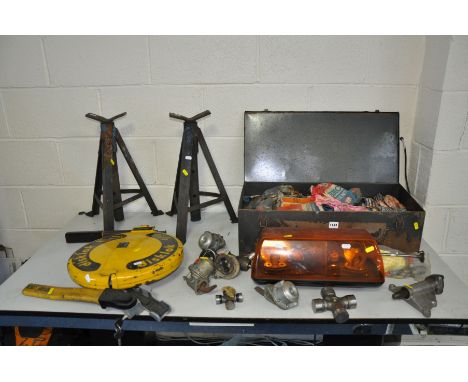 A PAIR OF VINTAGE AXLE STANDS, a tin trunk containing vintage vehicle spares including Universal joints, track rod ends, valv