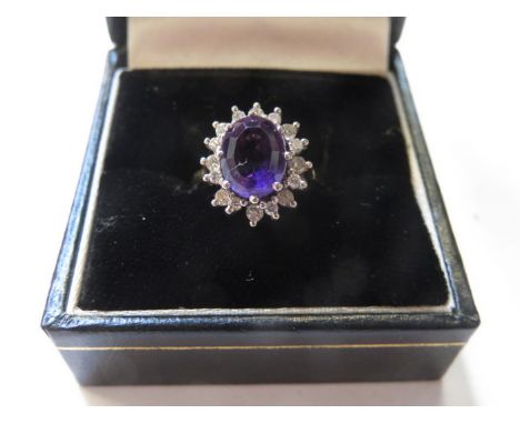 18ct GOLD DRESS RING SET WITH AMETHYST STONE SURROUNDED BY CLEAR STONES