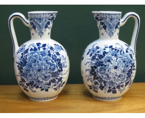 PAIR OF DELFT FLORAL DECORATED CERAMIC WATER JUGS, APPROXIMATELY 22cm HIGH 