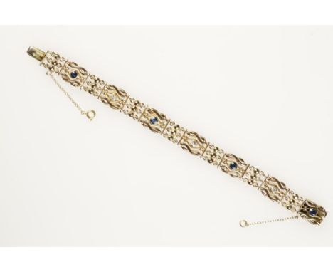 A 15CTS YELLOW GOLD BRACELET, four links set with round-cut sapphires, interspersed with three round-cut diamonds, with conce