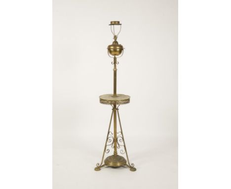 A LACQUER BRASS STANDARD LAMP, the onyx circular tier with an ornate fret pierced apron, raised on an openwork triform base w