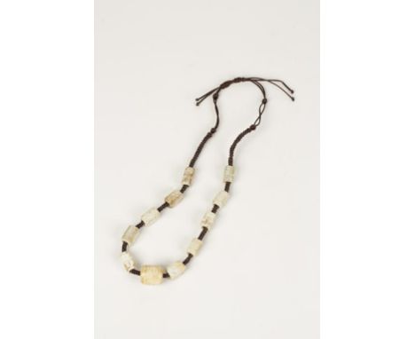 A SET OF ARCHAISTIC JADE CONG BEADS on a plaited silk necklace