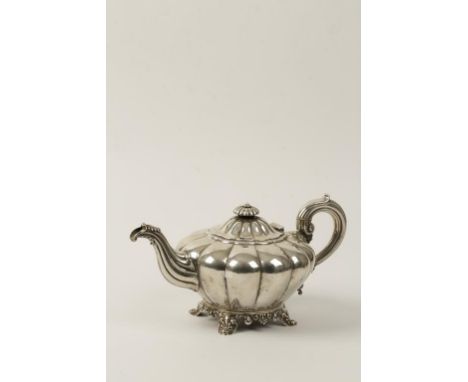 A VICTORIAN SILVER TEAPOT of melon form, scroll handle and fluted shell-capped spout, with disc finial, crested, on shell-cap