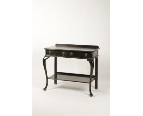 AN INDIAN EBONISED SERVING TABLE, the rectangular top with moulded border above two frieze drawers with lion mask handles, on