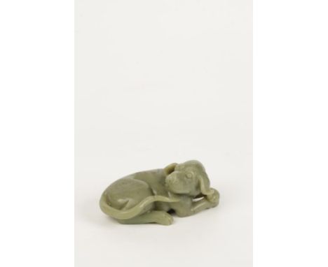 A CELADON JADE FIGURE OF A HOUND, modelled as the recumbent dog with its head turned to one side, 11cms wide