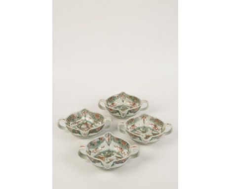 A SET OF FOUR CHINESE FAMILLE VERTE POURING VESSELS, the shaped two-handled bowls painted with phoenix and flowering stems, K