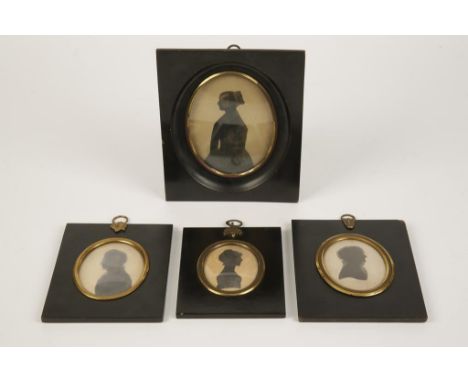 A 19TH CENTURY SILHOUETTE PORTRAIT MINIATURE of a lady dressed in a long gown, in an ebonised frame with gilt metal slip and 