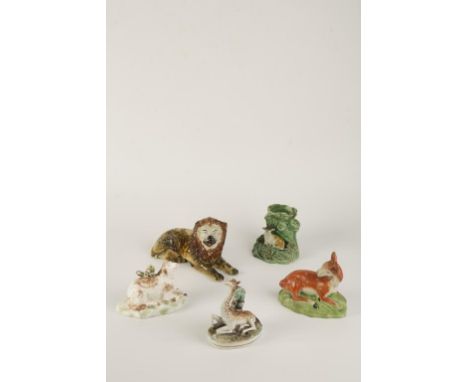 A VICTORIAN STAFFORDSHIRE GIRAFFE laying beside a palm tree, 4.5" high, an early Staffordshire pearlware deer laying on a gre