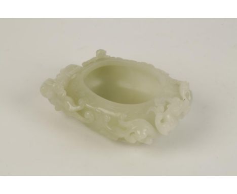 A CHINESE WHITE JADE BRUSH WASHER, of compressed baluster form, the sides carved in high relief with three chilongs and a pho