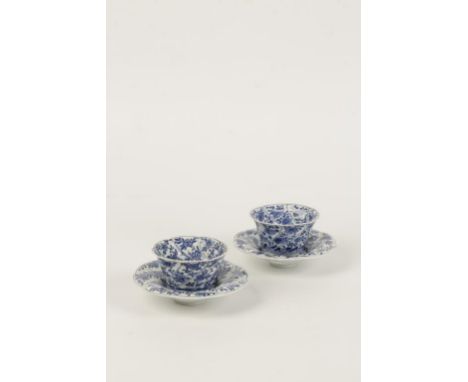A PAIR OF CHINESE BLUE AND WHITE CUPS, of lobed form painted with flower sprays, Kangxi period, 8cms diam