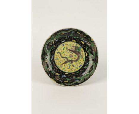 A CHINESE FAMILLE VERTE DISH, painted with dragons, clouds, flaming pearls and ruyi, Kangxi period, 23cms diam.