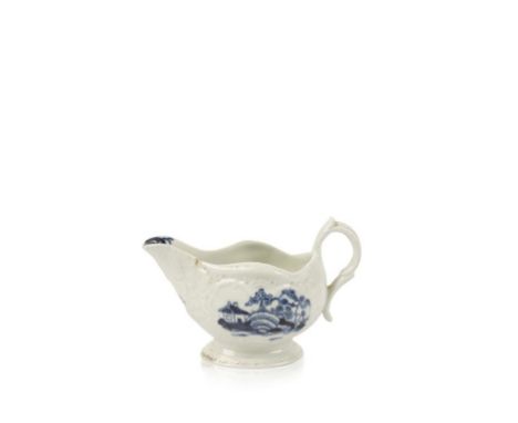 A FIRST PERIOD WORCESTER BLUE AND WHITE SAUCEBOAT, the press moulded silver shape body decorated with the "Cannonball" patter