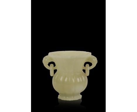 A CHINESE WHITE JADE 'LOTUS' VASE, the flared neck with twin lion mask loop handles with ovoid body and spreading foot, 11cms
