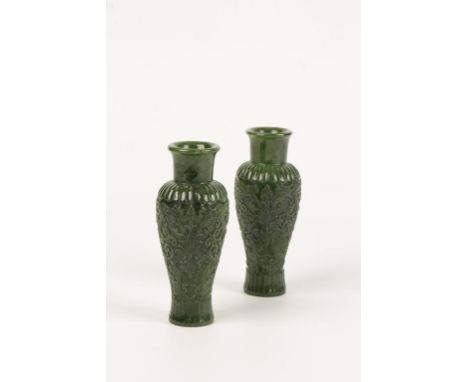 A PAIR OF SPINACH JADE VASES, of slender baluster form, the sides carved in relief with leafy scrolls and tendrils, 14cms hig