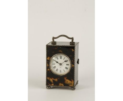 A FRENCH TORTOISESHELL AND SILVER CARRIAGE CLOCK, the round white enamel dial with Roman numerals, in a fitted tortoiseshell 