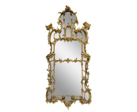 AN IMPORTANT EARLY GEORGE III GILTWOOD MIRROR in the manner of Thomas Johnson, with a divided shaped rectangular plate within