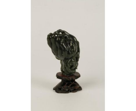 A CHINESE SPINACH JADE CITRUS FINGER OR BUDDAH HAND, of naturalistic form, 12cms long