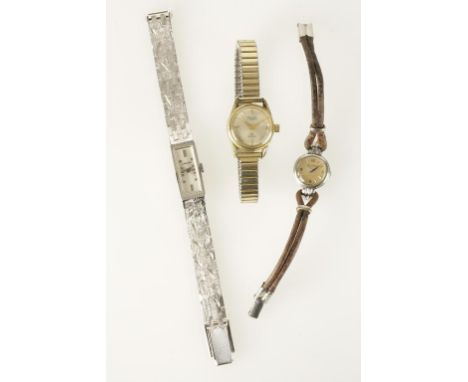 JAEGER LECOULTRE: A LADIES WHITE METAL WRISTWATCH, the round dial with baton and Arabic numerals, attached to a brown leather