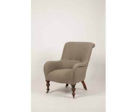 A VICTORIAN MAHOGANY AND UPHOLSTERED ARMCHAIR, covered in grey buttoned fabric, on turned legs with ceramic castors, 35.5" hi