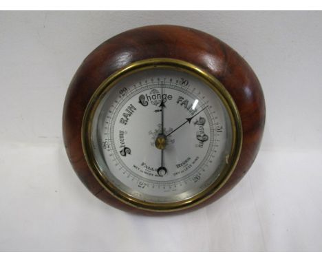 A wooden cased small round barometer