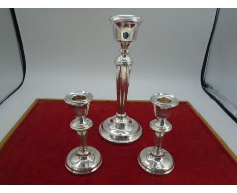 A pair of silver hallmarked candlesticks 1945-55 Birmingham by AL Davenport ltd. 11.5 cm high approx, total combined weight 2