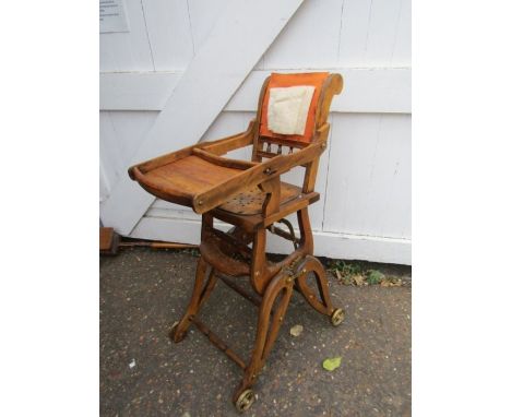 A vintage high chair- for display purposes, includes some material for seating