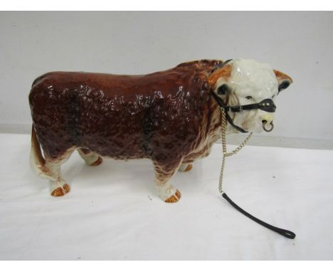A large ceramic Hereford bull 42cm long and 29ch tall rear leg has been repaired