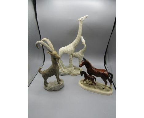 A ceramic giraffe, horses and onyx mountain goat. giraffe has damaged ear