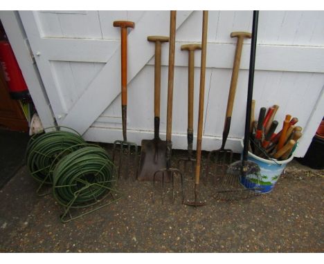 Mixed garden hand tools and hoses 