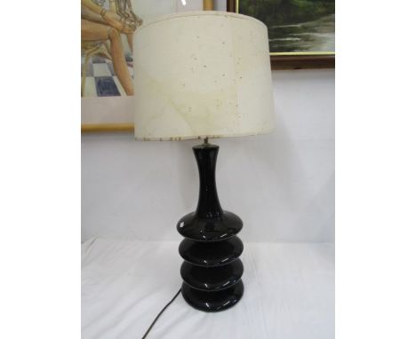 A tall black table lamp