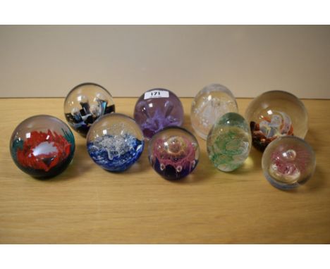 Nine assorted glass paperweights including Caithness and Selkirk glass etc.