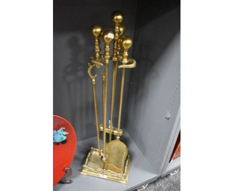 A Victorian brass fireside companion stand with tools, measuring 80cm tall