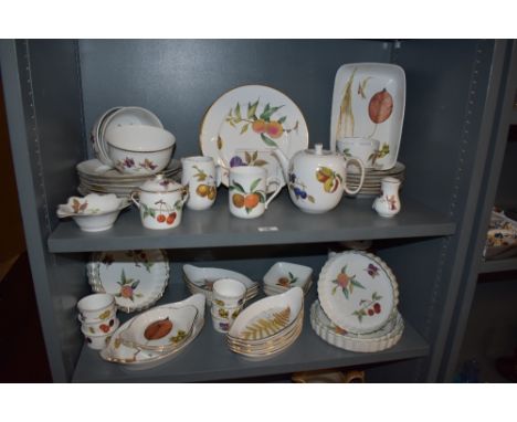 An assorted collection of Royal Worcester Evesham patterned tableware, including flan dishes, ramekins, and harvest serving d
