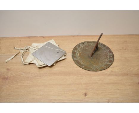An antique brass sundial, having Welsh dragons to centre, approx 17cm, sold with a Heliograph mirror.