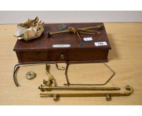 A cased set of brass scientific weighing scales