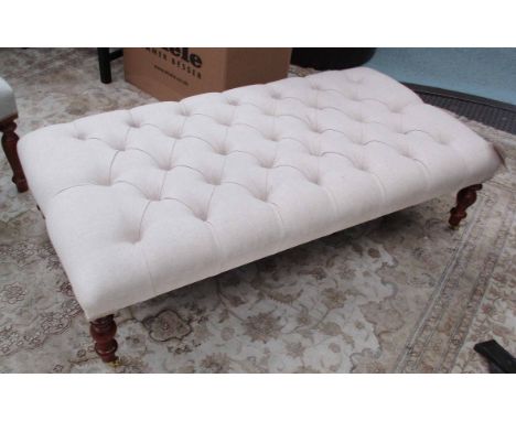 HEARTH STOOL, in buttoned neutral fabric on turned castor supports, 124cm x 62cm x 32cm H.