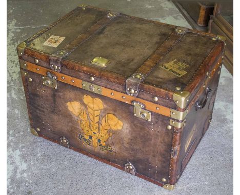 TRUNK, vintage style, brown leather and brass bound, bearing Prince of Wales feathers motif, travel labels, hinged top and ir