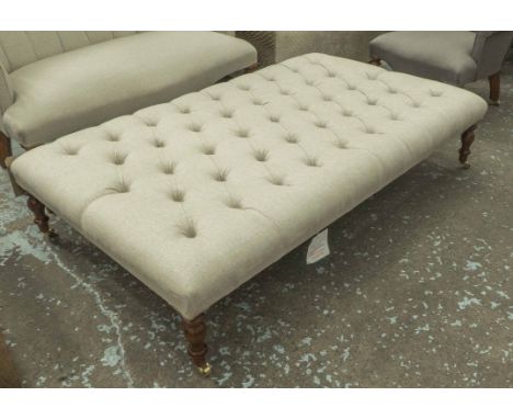 HEARTH STOOL, in buttoned neutral fabric on turned supports with castors, 151cm x 81cm x 33cm H.