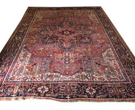 FINE ANTIQUE PERSIAN HERIZ CARPET, 355cm x 273cm, central pendant medallion on a terracotta palmette and vine field, within c