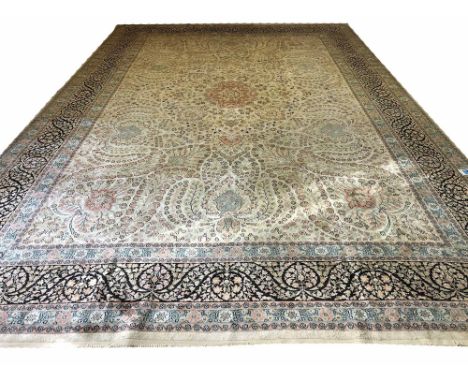 FINE PURE SILK HEREKE DESIGN CARPET, 550cm x 360cm, central medallion on an ivory palmette and vine field within matching ban