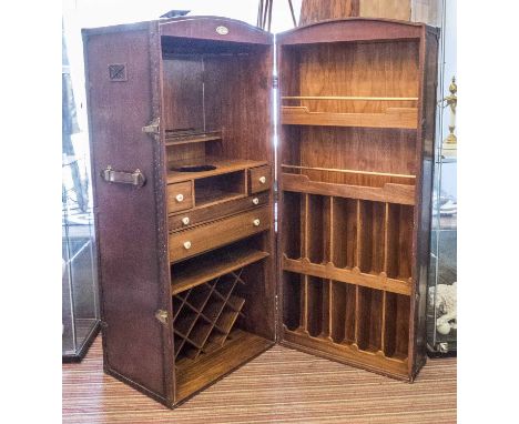 STARBAY BAR TRUNK, leather and brass bound with fitted interior of drawers and storage, 135cm H x 61cm closed x 122cm open. (
