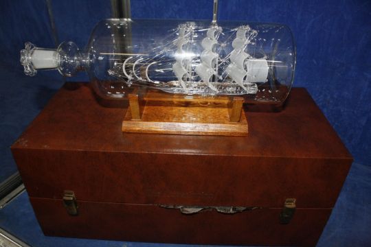 A Glass ship in a bottle by Lichfield glass, on wooden base Best Bid