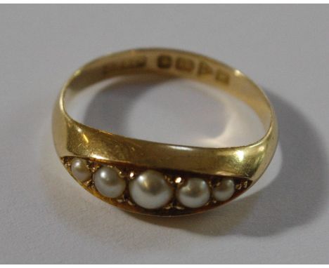 An 18ct gold ring set with five graduated pearls, ring size O approx.